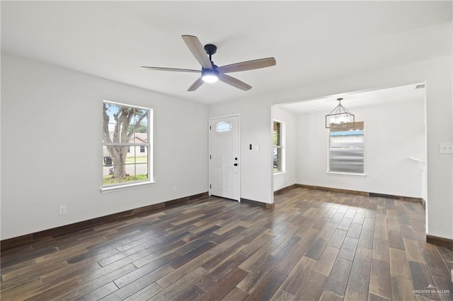 1815 W Adelita St, Weslaco, TX 78599 - foyer entrance featuring a chandelier, dark wood-style floors, and a ceiling fan