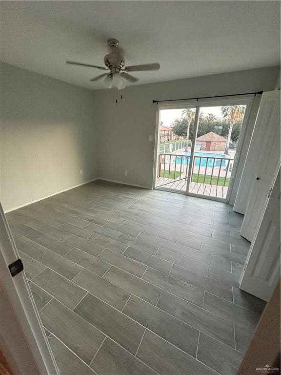 empty room featuring ceiling fan and dark wood-type flooring