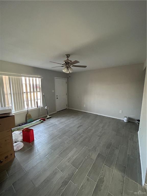 unfurnished room with ceiling fan and hardwood / wood-style floors