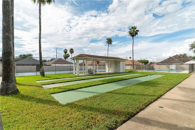 surrounding community featuring a lawn and fence