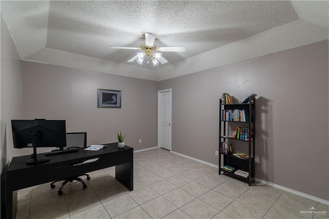 office area featuring light tile patterned floors, a raised ceiling, ceiling fan, a textured ceiling, and baseboards