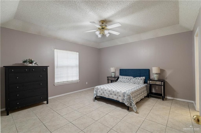 bedroom with light tile patterned floors, a textured ceiling, baseboards, and a ceiling fan