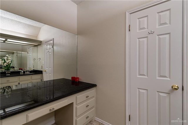 bathroom featuring vanity and baseboards