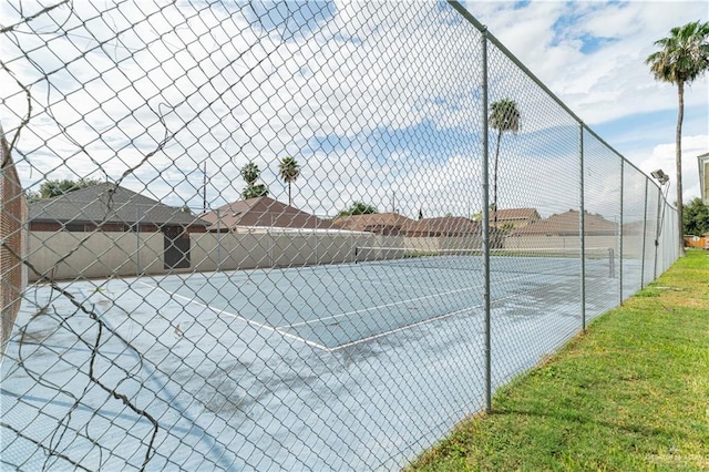 view of sport court featuring fence