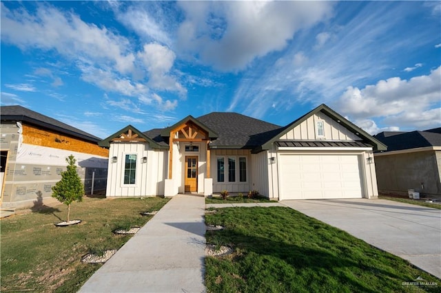 view of front of property with a garage and a front lawn