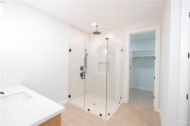 bathroom featuring vanity and an enclosed shower