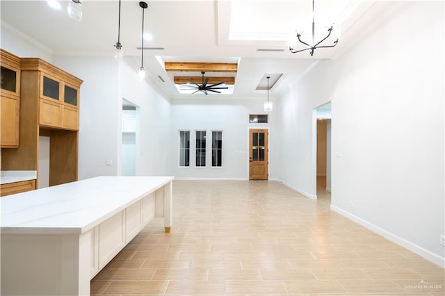 kitchen featuring light stone countertops, ceiling fan with notable chandelier, pendant lighting, light hardwood / wood-style floors, and a kitchen island