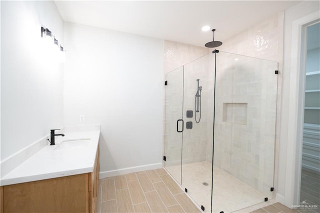 bathroom with vanity and a shower with shower door