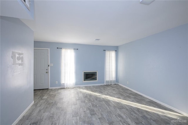 unfurnished living room with light hardwood / wood-style flooring