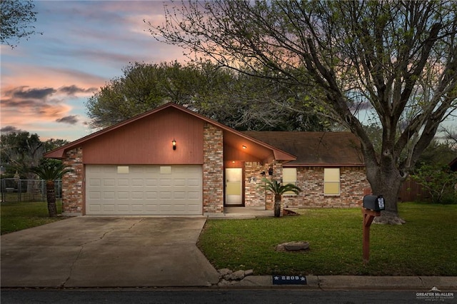 mid-century home featuring brick siding, concrete driveway, an attached garage, fence, and a front lawn