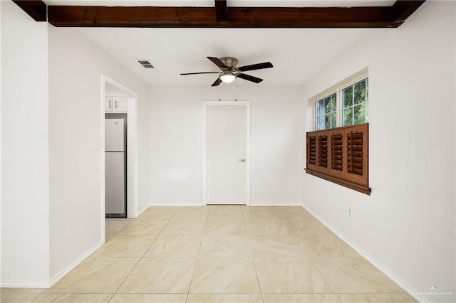 spare room featuring ceiling fan, baseboards, beam ceiling, and light tile patterned flooring