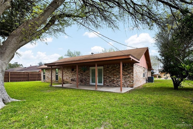 rear view of property with french doors, brick siding, central air condition unit, a patio area, and fence