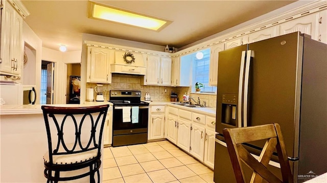 6916 Avenida Del Paseo St, Mission, TX 78572 - kitchen featuring stainless steel electric range, refrigerator with ice dispenser, light tile patterned floors, a sink, and light countertops