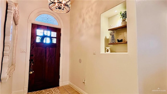 6916 Avenida Del Paseo St, Mission, TX 78572 - foyer entrance with a chandelier, baseboards, and light tile patterned floors
