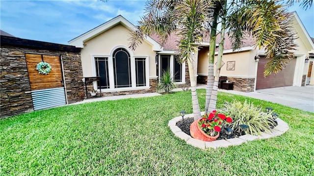 6916 Avenida Del Paseo St, Mission, TX 78572 - view of front of house featuring stone siding, stucco siding, concrete driveway, a front lawn, and a garage