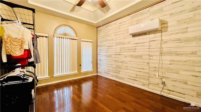 6916 Avenida Del Paseo St, Mission, TX 78572 - empty room featuring an AC wall unit, wood finished floors, a ceiling fan, baseboards, and wooden walls