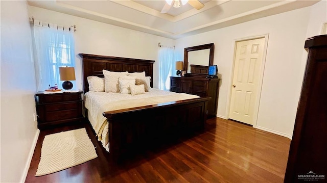 6916 Avenida Del Paseo St, Mission, TX 78572 - bedroom with dark wood-type flooring, baseboards, a raised ceiling, and ceiling fan