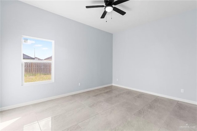 spare room featuring ceiling fan and light tile patterned flooring