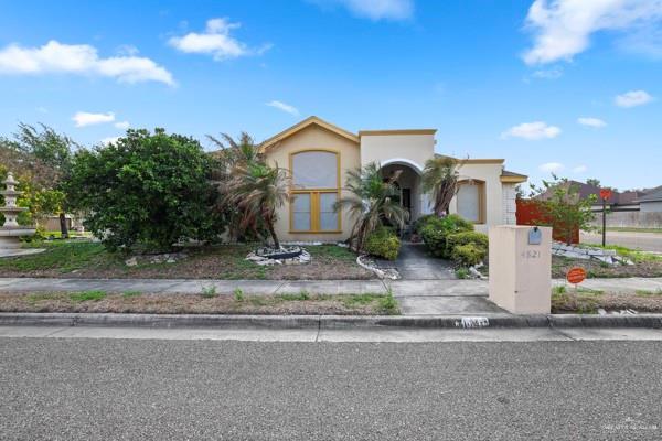 view of front of home featuring concrete driveway, an attached garage, and stucco siding