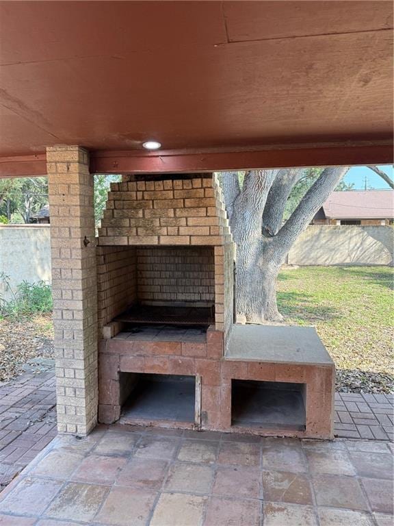 details featuring exterior fireplace and fence