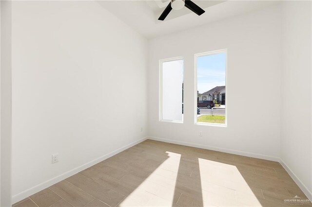 empty room with ceiling fan and light wood-type flooring