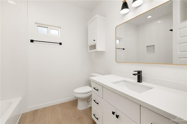 full bathroom with hardwood / wood-style floors, vanity, toilet, and shower / bath combination