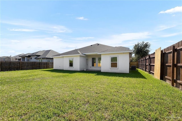 rear view of property with a lawn