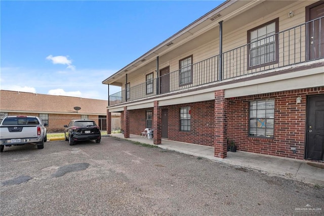 view of side of property featuring a balcony