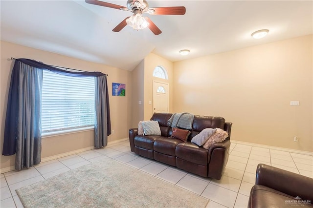 tiled living room with lofted ceiling and ceiling fan