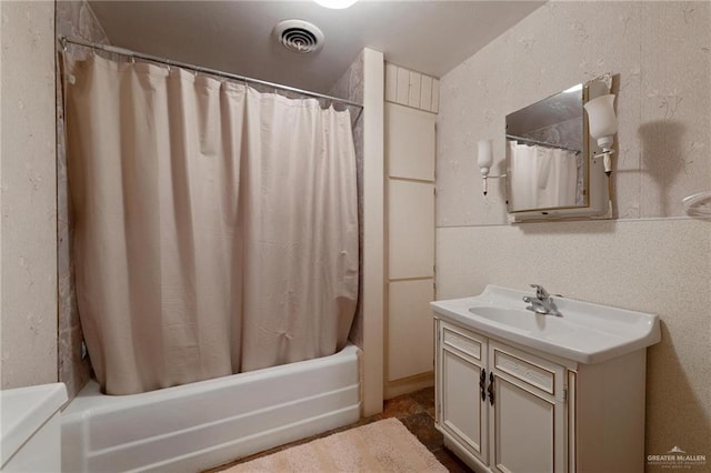bathroom with visible vents, shower / bath combination with curtain, and vanity