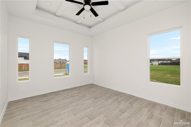 empty room with beamed ceiling, ceiling fan, light hardwood / wood-style flooring, and coffered ceiling