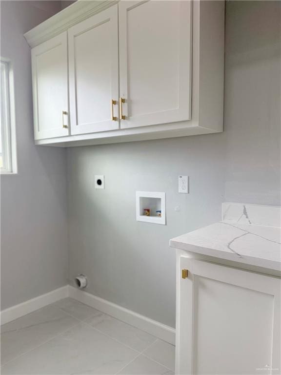 clothes washing area featuring electric dryer hookup, cabinets, and hookup for a washing machine