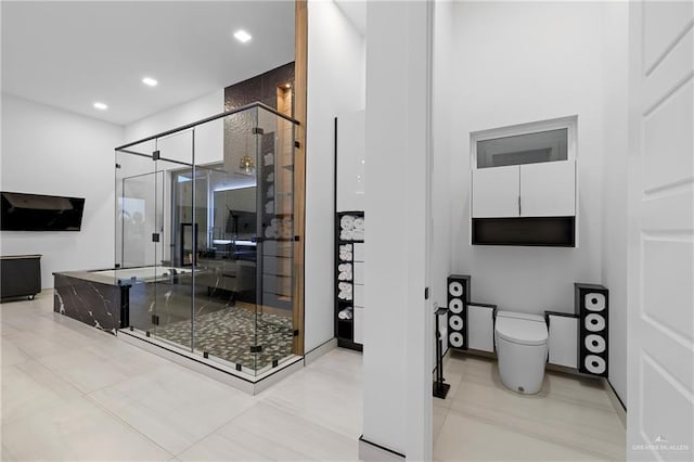 bathroom featuring walk in shower, toilet, and tile patterned flooring