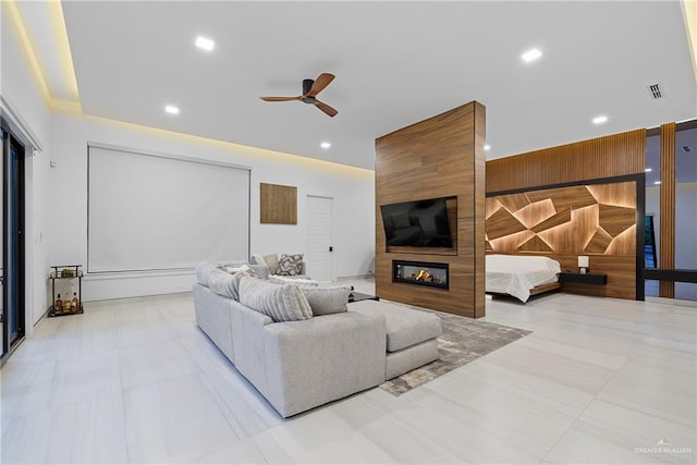 living room with a fireplace and ceiling fan