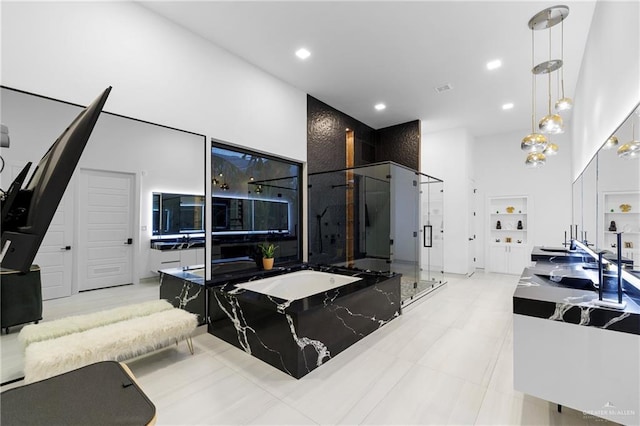 kitchen with hanging light fixtures and a towering ceiling