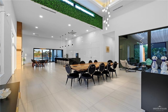 dining space featuring a high ceiling and plenty of natural light