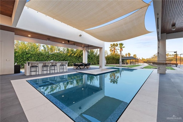 view of pool with a gazebo, a bar, and a patio