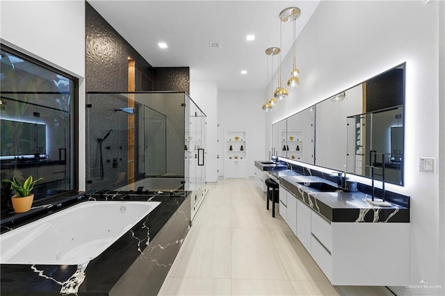 bathroom featuring vanity, tile patterned floors, and plus walk in shower