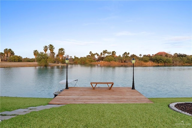 view of dock featuring a water view and a lawn