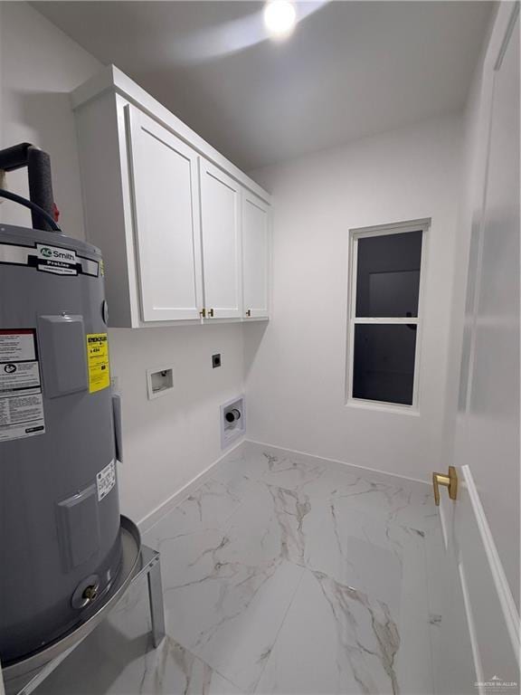 clothes washing area featuring electric water heater, cabinet space, electric dryer hookup, baseboards, and marble look tile flooring
