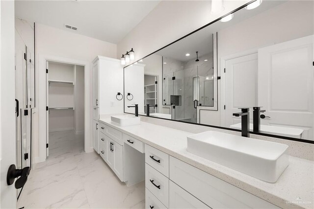 1008 N Buxton Ave, Edinburg, TX 78541 - bathroom featuring a stall shower, marble look tile flooring, a spacious closet, and double vanity