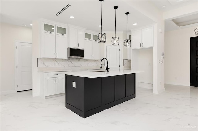1008 N Buxton Ave, Edinburg, TX 78541 - kitchen with a sink, tasteful backsplash, white cabinetry, light marble finish floors, and recessed lighting