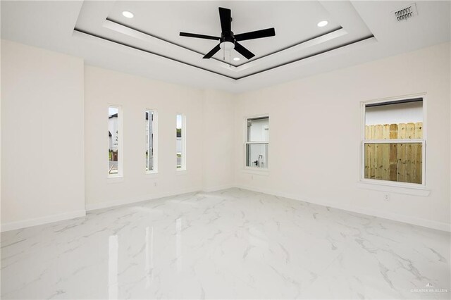 1008 N Buxton Ave, Edinburg, TX 78541 - spare room featuring baseboards, recessed lighting, marble finish floors, ceiling fan, and a tray ceiling
