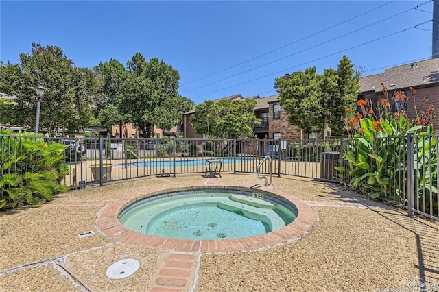 view of pool featuring a hot tub