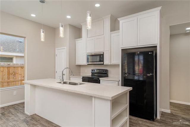 kitchen featuring wood finished floors, black appliances, open shelves, and a sink