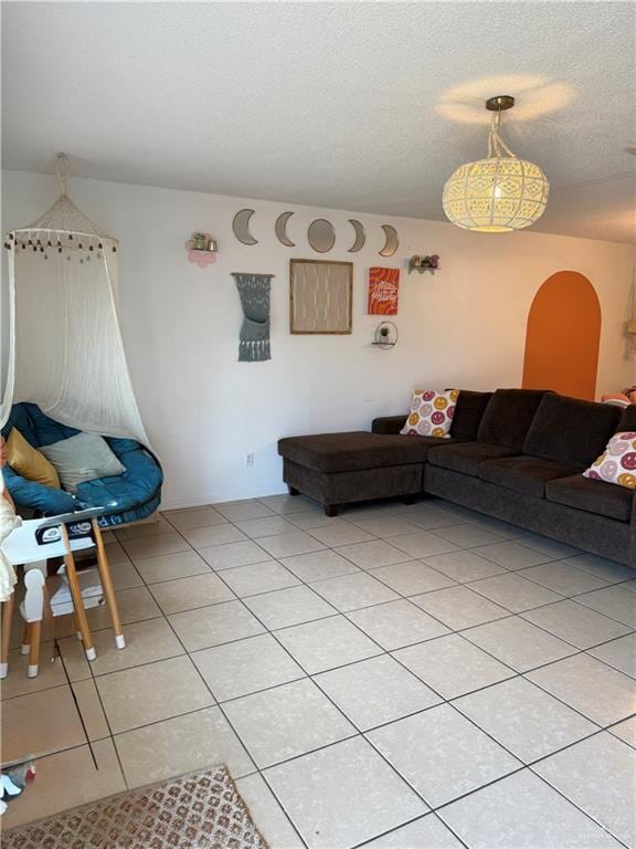 1341 Kokopelli Dr, Edinburg, TX 78541 - living room with light tile patterned floors and a textured ceiling