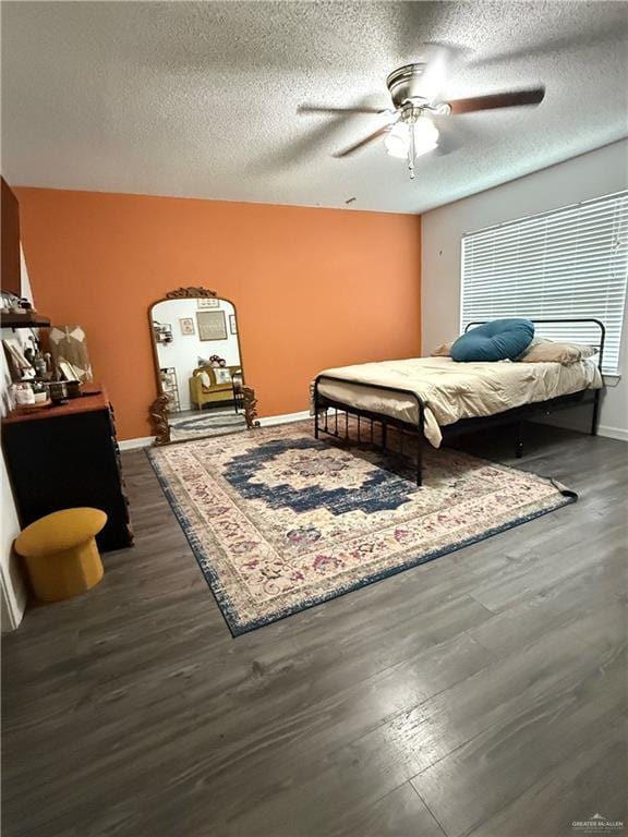 1341 Kokopelli Dr, Edinburg, TX 78541 - bedroom featuring a textured ceiling, dark wood-style flooring, ceiling fan, and baseboards