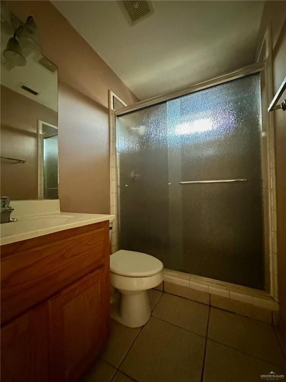 bathroom featuring a stall shower, visible vents, toilet, tile patterned flooring, and vanity