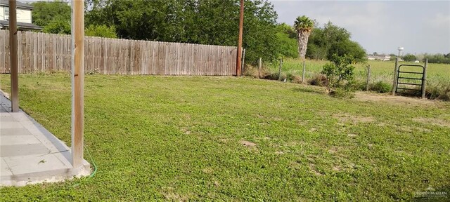 view of yard featuring a patio area and fence