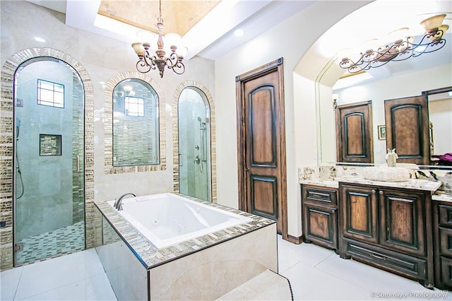 full bathroom with tile patterned floors, a tub with jets, an inviting chandelier, tiled shower, and vanity